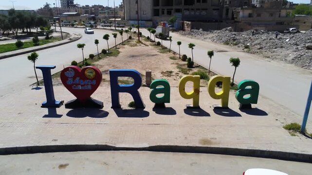 Aerial drone shot of I Love Raqqa landmark roundabout in Raqqa Syria urban cityscape