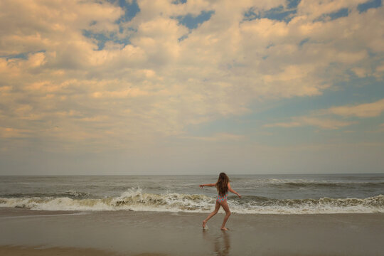Behind young girl dancing on the beach Cape Hatteras National Se
