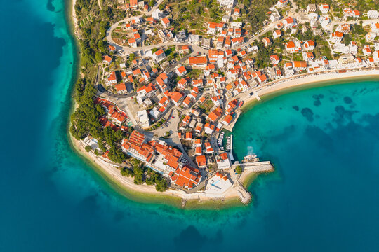 Makarska riviera. Aerial view of a small coastal town Igrane on the Adriatic coastline. Residential buildings and a beach with clear turquoise water