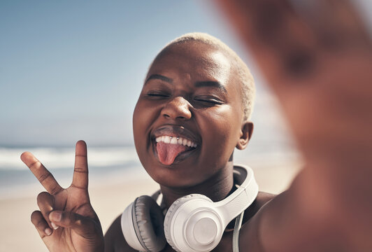 Fitness, selfie and black woman on beach with peace sign for workout, sport or exercise in nature. Tongue out, smile and runner with tech for social media, blog or profile picture for summer training
