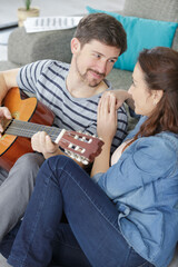 Fototapeta premium music playing lesson lovers couple at living room