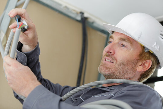 man working with cables indoors