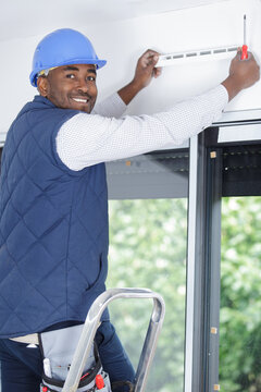 happy maintenance technician looking at camera