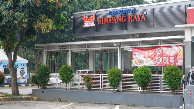 Simpang Raya Padang restaurant in front with a glass display case, there are many kind of menu on the plate. Padang restaurant logo signboard. Restaurant in The Trans-Java Toll Road Rest Area.