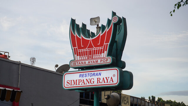 Simpang Raya Padang restaurant in front with a glass display case, there are many kind of menu on the plate. Padang restaurant logo signboard. Restaurant in The Trans-Java Toll Road Rest Area.
