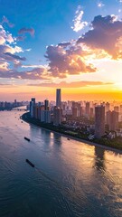 Obraz premium A breathtaking aerial view captures a sprawling cityscape along a winding river bathed in the warm hues of a vibrant sunset, showcasing modern architecture and tranquil waters.