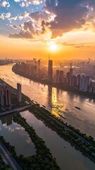 Fototapeta premium An aerial view captures a vibrant cityscape bathed in the warm glow of a setting sun, reflecting beautifully on the winding river below.