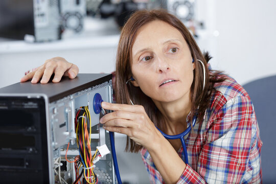 woman working in technical support fixing computer laptop
