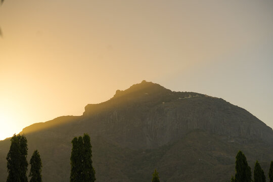 Golden sunrise at Girnar hills , junagadh , Gujarat with dramatic sky, Mistry mountains and spiritual atmosphere near the famous pilgrimage site