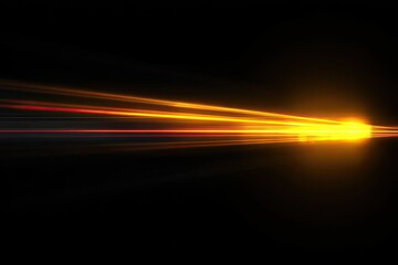 Fototapeta premium A burst of golden light streaks across a dark background, creating a dynamic and energetic visual effect.