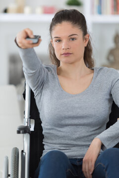 disabled woman in wheelchair watching tv at home