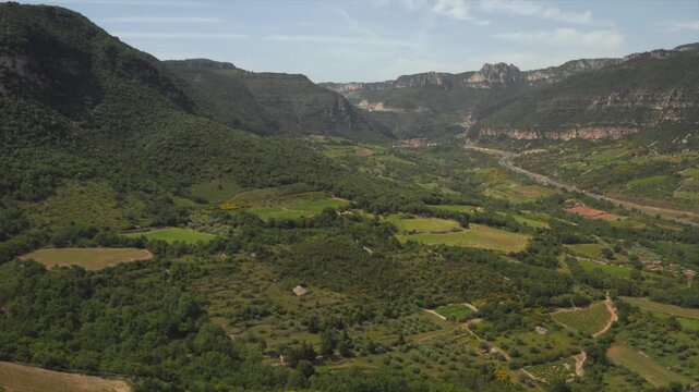 Sunlit drone view of the Terrasses du Larzac hills and valleys