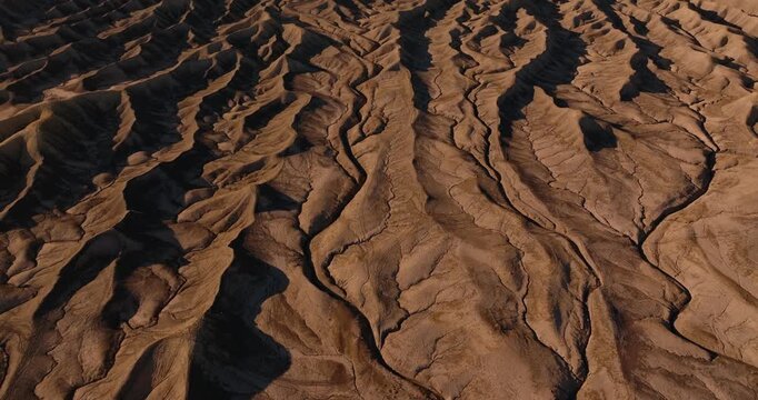 Close aerial overview of intricate erosion lines across dry Utah desert badlands, Factory Butte
