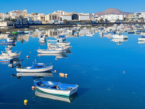 Arrecife harbor boats reflecting on quiet water