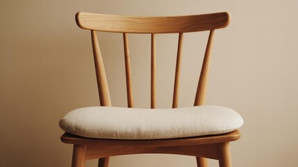 Fototapeta premium A wooden chair in front of a beige wall.