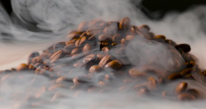 Extreme close-up of roasted coffee beans with visible steam rising, highlighting rich texture and warmth in soft, cinematic lighting. Shallow depth of field with smooth background blur