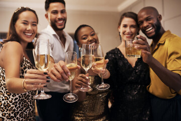 Portrait, friends and drinks at party with toast, bonding together and celebration for new years eve. Night, people and cheers at social event with champagne glass, alcohol or solidarity for reunion. © peopleimages.com