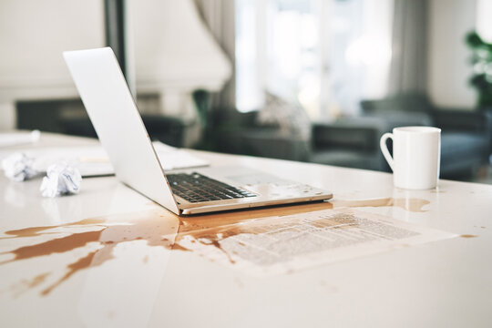 Laptop, coffee and spill with accident, issue and office mistake with document. Keyboard splash, chaos and computer crisis with tech, mess and clumsy fail with liquid trouble and damage paperwork