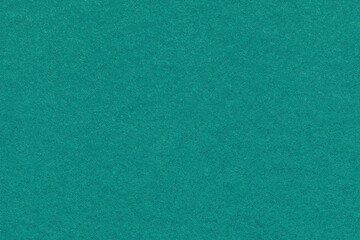 Fototapeta premium Teal textured paper background with subtle grain surface and soft structure. Emerald green backdrop, macro