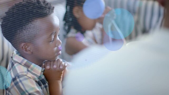 Parent starting prayer at table, kids bowing with hands clasped for health while circles overlaying