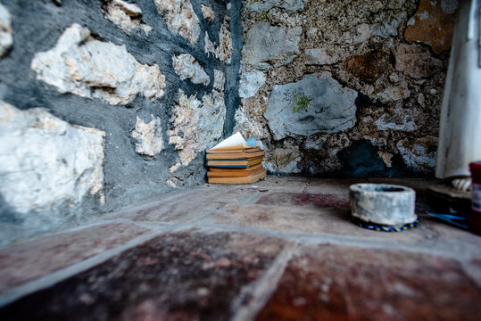 Stack of books on rustic stone floor