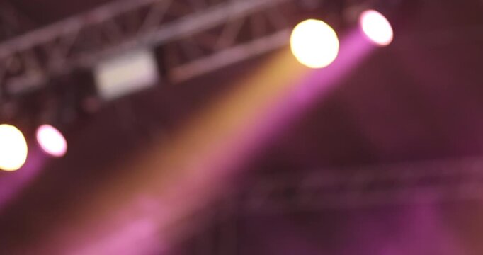 Blurred stage spotlights at night in purple pink tones with dynamic motion. Creates concert and event atmosphere, ideal for intros, backgrounds, and motion graphics