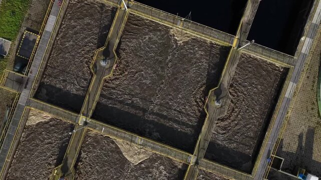 Aerial view of the geometric water treatment plant, showcasing its pools and connecting pathways, a vital part of the city's infrastructure, Lisbon, Portugal.