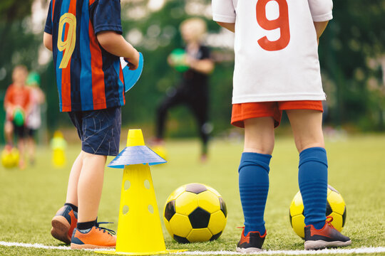 Youth Soccer Training Session; Kids Standing with Ball and Cones on Practice Field