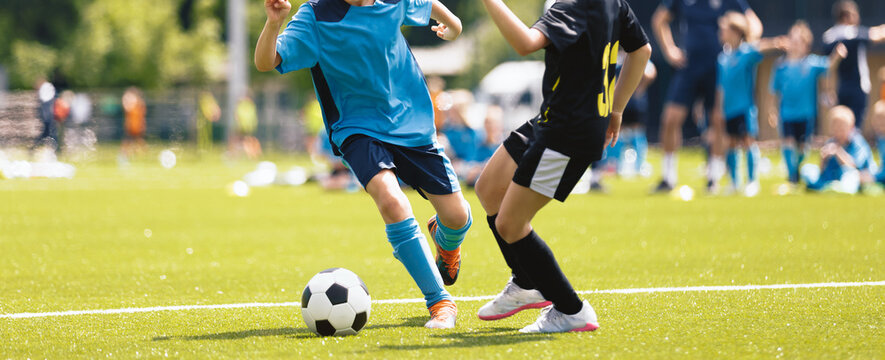 Youth Soccer Match Action; Kids Competing for Ball During Football Game on Grass Field