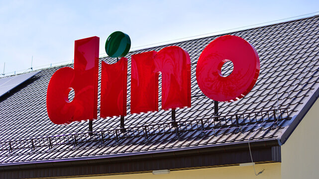 Wesola, Poland. 13 April 2026. Sign board Dino with brand logotype above entrance.