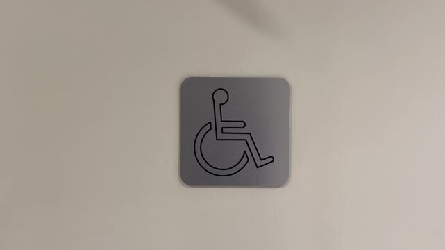 The door to a disabled toilet with disabled signage.