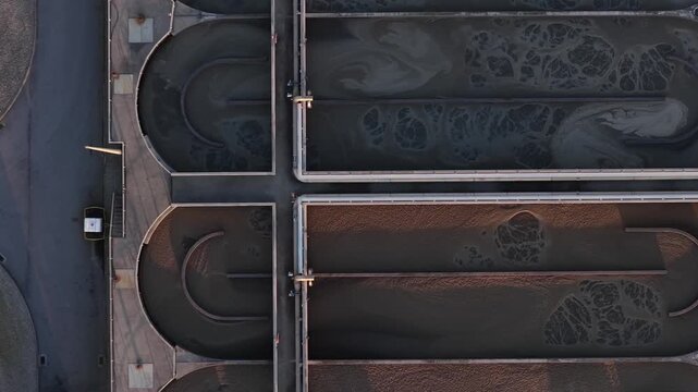 Aerial view of the geometric patterns formed by the settling tanks of a water treatment facility, creating textures, Lisbon, Portugal.