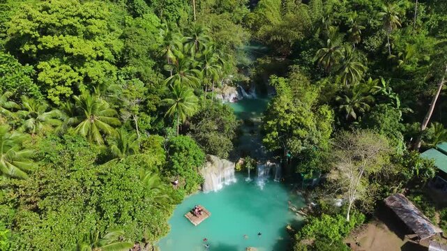 Aerial drone fly over tropical waterfall lagoon in Cambugahay Falls Siquijor Philippines