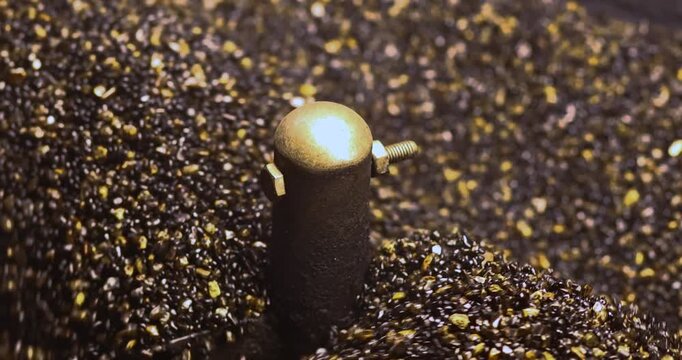 Roasting Sand for Chestnuts in a hot pan, close-up. rolling and heating. Ideal for food, snack, street food, and cozy winter concepts