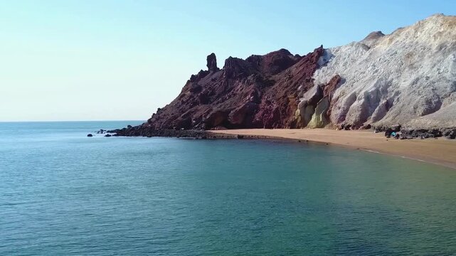 A breathtaking coastal view of Hormuz Island, Iran, widely known as the "Rainbow Island" for its extraordinary geological diversity. Located in the strategically vital Strait of Hormuz, a strategic lo