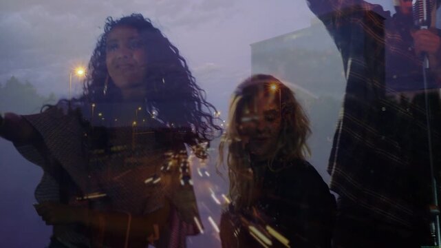 Lead vocalist raising arm and singing, band performing song, dancers clapping, road overlay moving