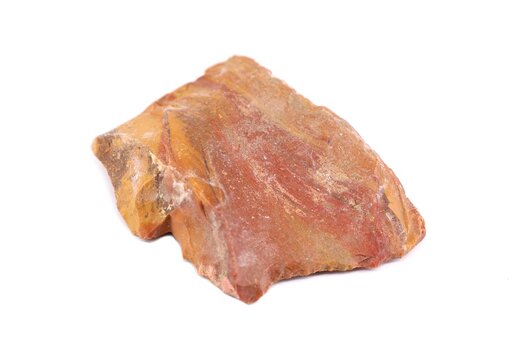 Piece of raw polychrome jasper gemstone on white background.