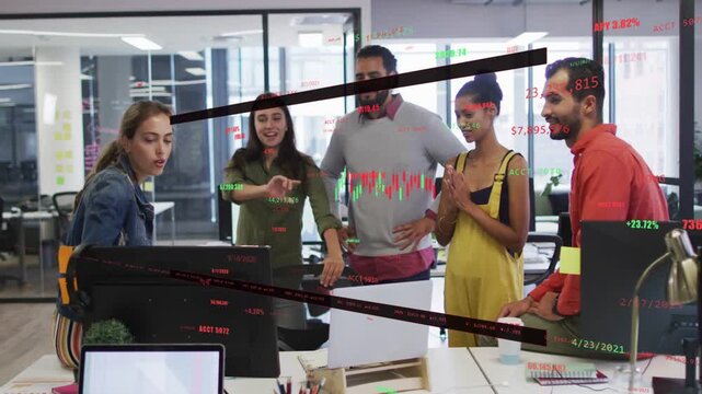 Seated woman manipulating mouse, updating overlaid stock charts while team pointing and approving