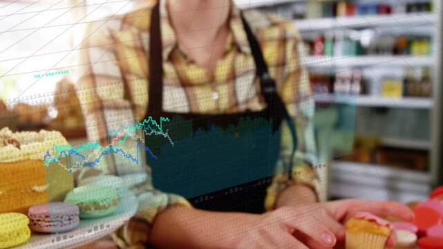Bakery staff hands entering frame, arranging cupcakes on board for display while charts overlaying