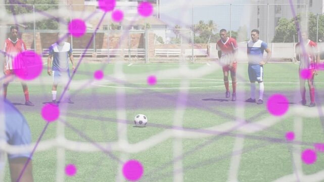 Red kicker taking runup striking ball into goal, GK moving, sports nodes growing, aiming to score