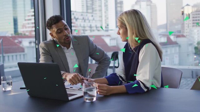 Man pointing with pen starting review, pair noting and clarifying docs while green triangles moving