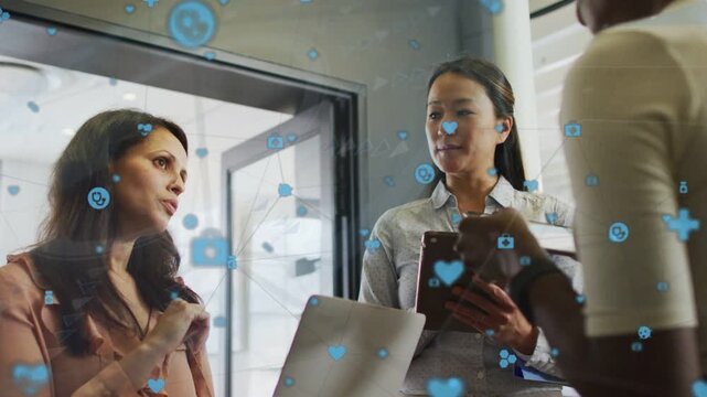 Host gesturing starting biz review woman tapping tablet left woman replying blue icons overlaying
