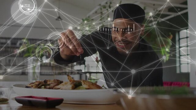 Chef leaning pinching garnish finishing plate as AR dials and charts showing values near hand or pla