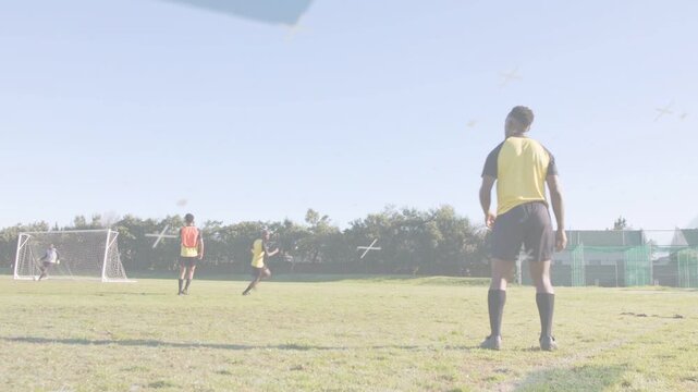 Right soccer player lifting ball overhead, releasing pass during drill, teammates running goalward