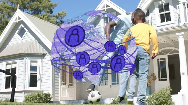 Dad tapping soccer ball, dribbling, teaching son while sports AR globe with nodes syncing