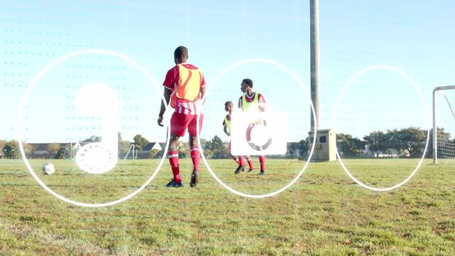 Male players dribbling soccer ball on grass, drill starting with pass, animated overlays flashing
