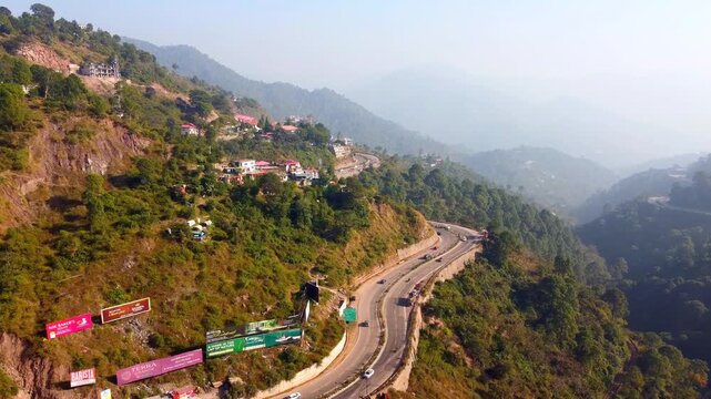 Aerial Drone View of Chandigarh Shimla Highway with Hillside House, Lush Green Mountains and Zigzag Road Traffic