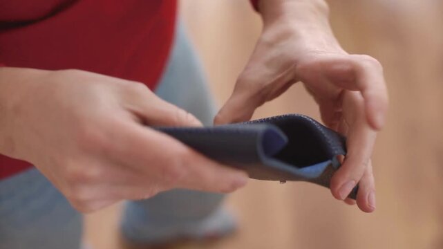woman shows her empty purses. Bankruptcy empty wallet clutches. The concept of poverty and shopping