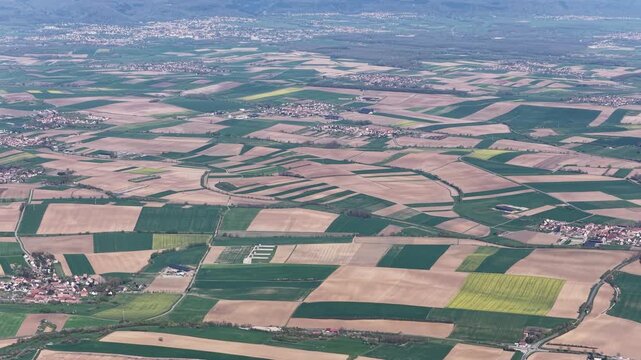 Aerial view of patchwork fields create a beautiful mosaic of textures and tones, highlighting the rural landscape, Wintzenheim-Kochersberg, Grand Est, France.