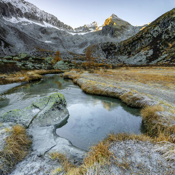 Mountain landscape with stream flows in Alveo Presena,Trentino,Tonale Pass,Italy, showcasing tourism and exploration.